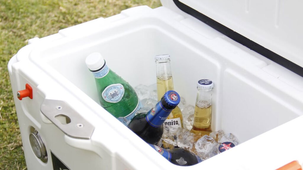 Drink cooler, ice chest with various drinks & alcoholic beverages.