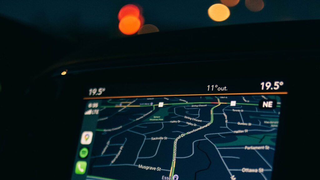 Car GPS giving directions at night on a road trip to a music festival